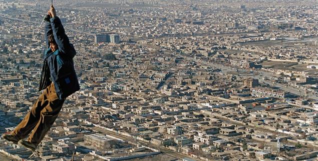 Über Kabul: Junge beim Spiel am Drahtseil, 2004 (Foto: Martin Gerner: »Finding Afghanistan. Fotografien 2001–2021«. modo. 208 Seiten. 32 €)