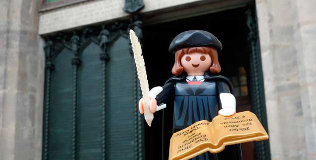 Playmobil-Luther vor der Thesentür an der Schlosskirche in Wittenberg: Am 31. Oktober 1517 soll der echte Reformator seine 95 Thesen hier eigenhändig an die Tür genagelt haben. (Foto. pa/Kasper/FSU)
Playmobil-Luther vor der Thesentür an der Schlosskirche in Wittenberg: Am 31. Oktober 1517 soll der echte Reformator seine 95 Thesen hier eigenhändig an die Tür genagelt haben. (Foto. pa/Kasper/FSU)